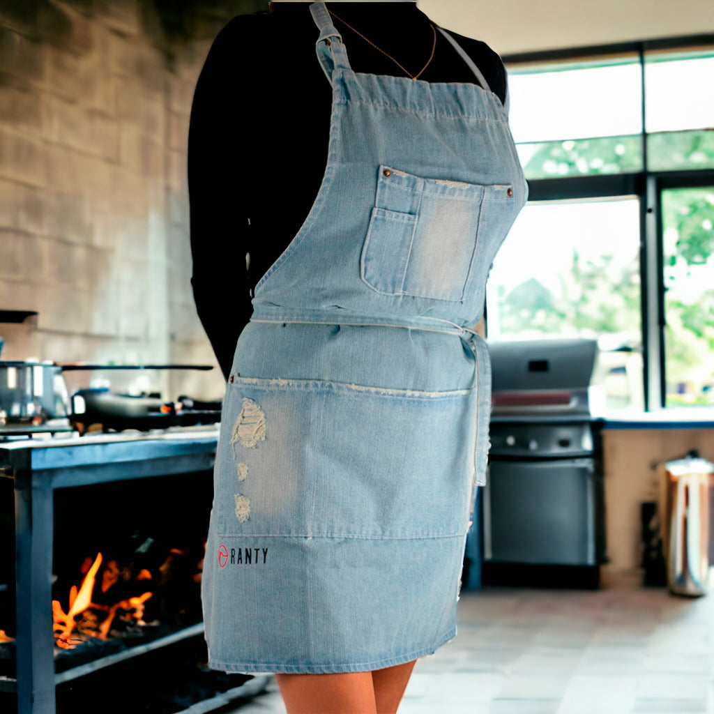 Delantal de cocina vintage jeans Ranty azul claro en ambiente de cocina con parrilla.